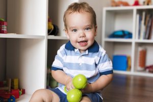 front view happy cute baby boy playing with toys front view happy cute baby boy playing with toys